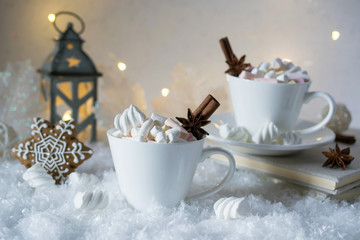 Wall Mural - Blurred background of winter frost and Christmas chocolate spice beverage with cookies in white cups