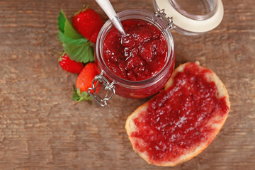 Sticker - Piece of bread and strawberry jam in jar on wooden table