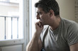 © Wordley Calvo Stock - sad and worried man with grey hair sitting at home couch looking