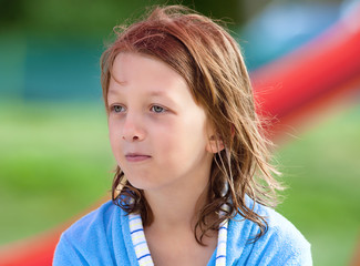 Portrait of a Boy with Blond Long Hair in Blue