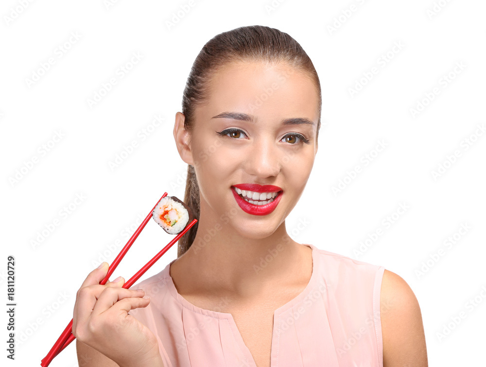 Beautiful young woman with sushi roll on white background