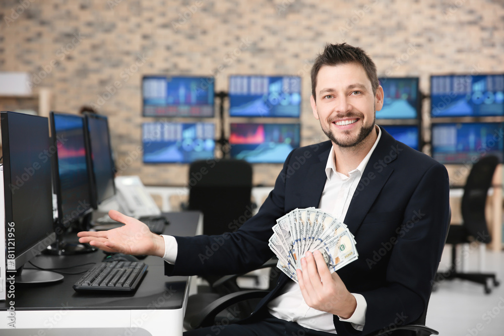 Male stock trader working in office