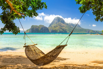 traditional braided hammock in the shade on a tropical island