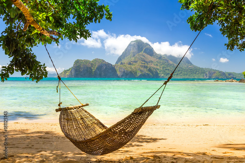 Traditional braided hammock in the shade on a tropical island Poster Mural XXL