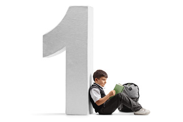 Poster - Little schoolboy reading a book and leaning against a cardboard number one