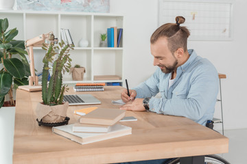 Wall Mural - disabled man writing in notebook