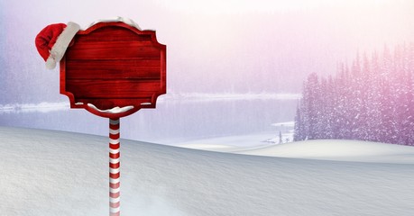 Poster - Wooden signpost in Christmas Winter landscape and Santa hat