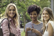 © PhotoAlto - Young women smiling together outdoors, portrait