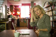 © PhotoAlto - Mature woman looking away distractedly while using laptop at home