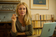 © PhotoAlto - Mature woman sitting at home with laptop computer, portrait