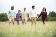 © PhotoAlto - Family walking together in field