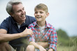 © PhotoAlto - Father and son laughing together outdoors