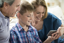 Family Looking At Smartphone Together