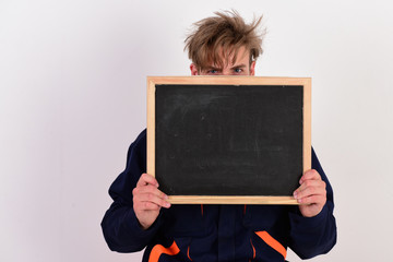 Wall Mural - Mechanic or repairer holds blackboard with copy space