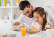 © Syda Productions - happy family eating flakes for breakfast at home