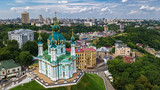 Fototapeta Miasto - Aerial top view of Saint Andrew's church and Andreevska street from above, cityscape of Podol district, city of Kiev (Kyiv), Ukraine
