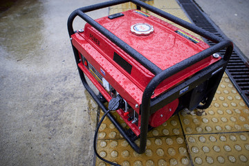 Electric generator, used in the rain on the ground. Fuel motor