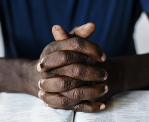 Wall Mural - African American male hands resting on an open bible