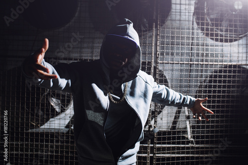 Fotografie, Obraz Modern rapper dancing in garage. Urban lifestyle, hip hop.
