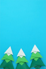 Canvas Print - Handmade origami paper craft Christmas tree on blue paper