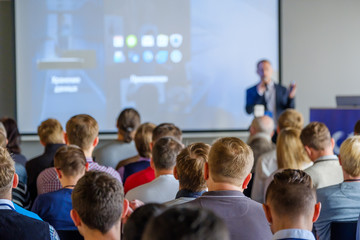 Audience listens to the lecturer at the conference hall