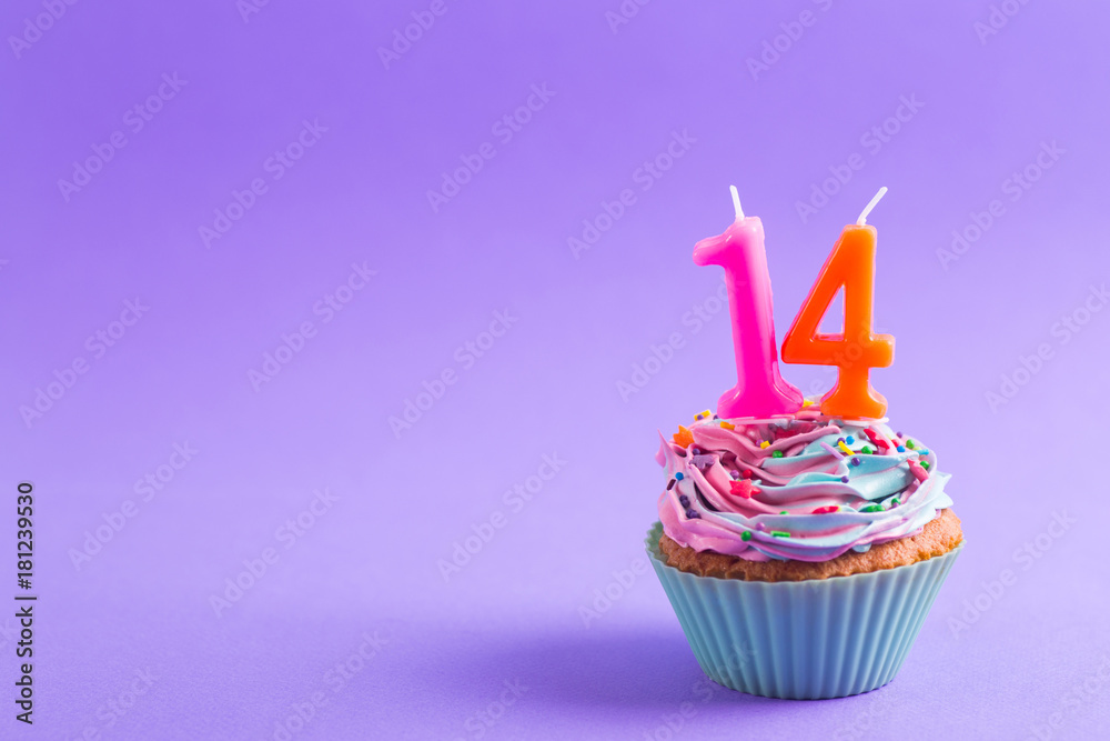 Festive creamy cupcake with sprinkles and candles in the form of number 14 on purple background - obrazy, fototapety, plakaty 