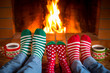 © Sunny studio - Family in Christmas socks near fireplace