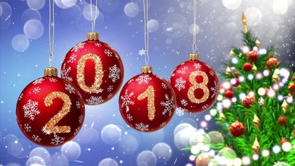 Wall Mural - red balls with numbers 2018 hanging on the background of a blue bokeh and a rotating christmas tree 