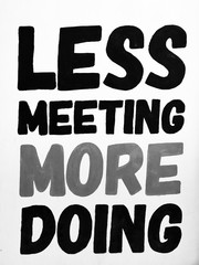 Wall Mural - Less meeting more doing words on wall, text quote on wall background in business room.