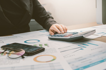 Close up hand of businesswoman accountant or banker using calculator, business finance calculation concept