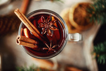 Christmas Hot Mulled Wine In A Glass With Spices And Citrus Fruit. Mulled Wine With Cinnamon, Anise And Orange