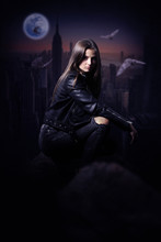 Beautiful Mysterious Woman In Black Leather Jacket Overlooking The City During The Night.Book Cover.