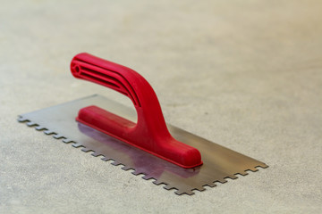 Canvas Print - Construction notched trowel is a tool for tiles installation work