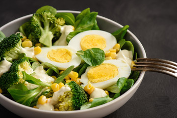 Healthy vegetarian salad with eggs, broccoli, corn and cheese