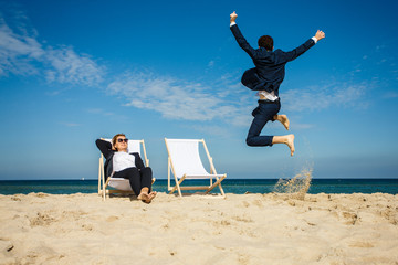 Wall Mural - Woman and man relaxing on beach