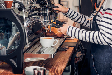 Poster - Close up woman barista making hot coffee with machine at counter bar in cafe restaurant,Food and drink service concept