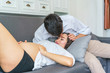 © bixpicture - Handsome man kiss beautiful pregnant woman at living room. concept of pregnancy, family and lover relation.