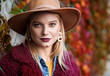 © Yakobchuk Olena - Portrait of confident young woman near twisting plant leaves. She is wearing stylish hat and slightly smiling. Autumn concept. Copy space in right side