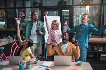 Aufkleber - Our success. Cheerful international qualified young team members are screaming and expressing their positive emotions while finishing important business project
