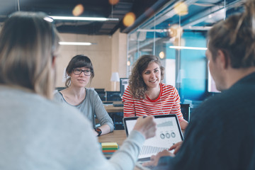 Wall Mural - Meeting room concept. Marketing business discussion in cozy open space office. Four people