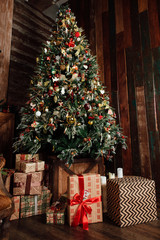 decorated christmas tree and presents in a box. new year's atmosphere.