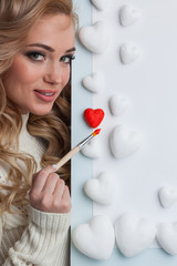 Wall Mural - Woman painting red hearts