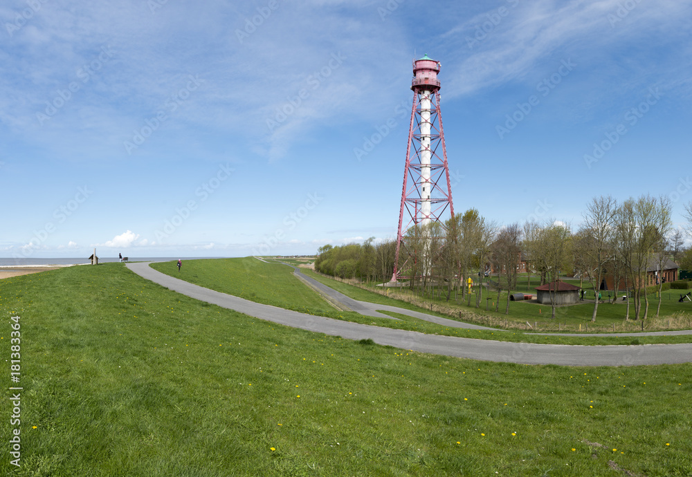Deutschland, Niedersachsen, Ostfriesland, Krummhrn, Der Leuchtturm Campen  (1890 fertiggestellt) ist der hchste Leuchtturm in Deutschland. Er steht  an der Mndung der Ems in die Nordsee. Stock Photo | Adobe Stock