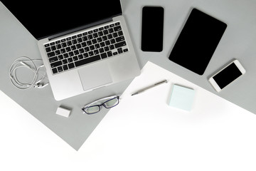 flat lay photo of office table with laptop computer, notebook, digital tablet, mobile phone, pencil 