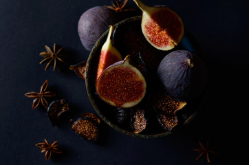 Close-up Picture of Fresh and dried Deep Blue Figs on a Dark Background.