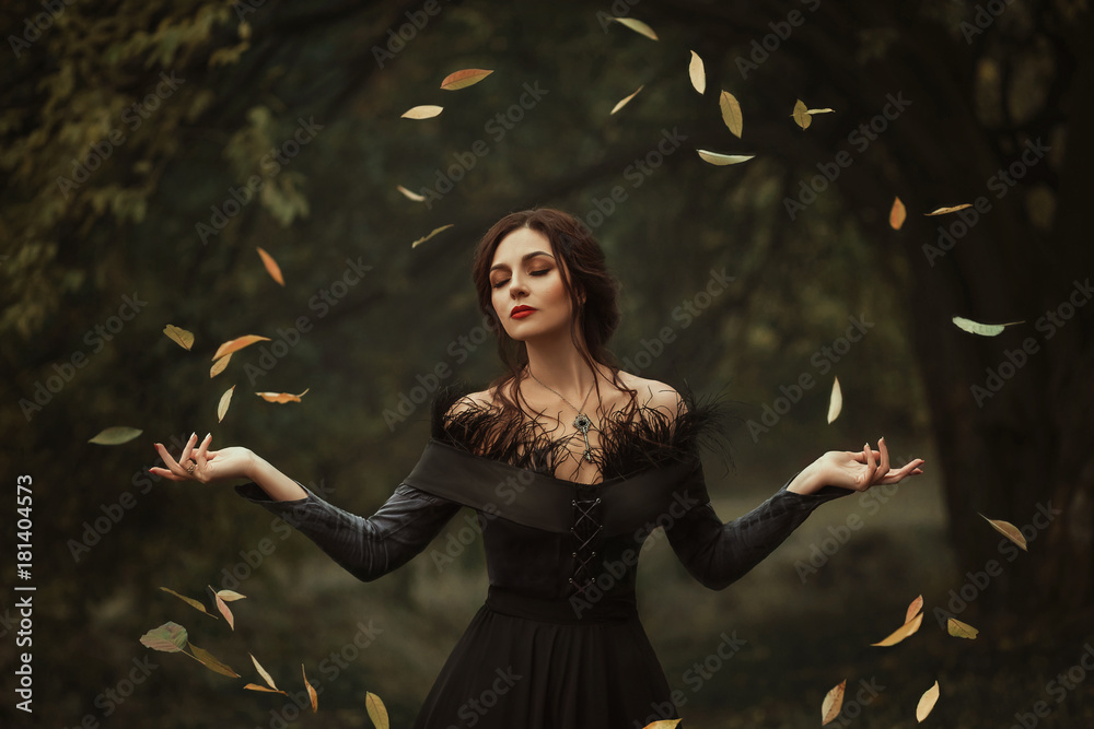 Incredible, amazing, seductive girl, in a black dress , magic rotates the  leaves. background is fantastic autumn. Artistic photography. Fantasy  gothic woman dark queen. Lady medieval witch Stock Photo | Adobe Stock