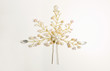 Beautiful hairpin decorated white pearls over a white background