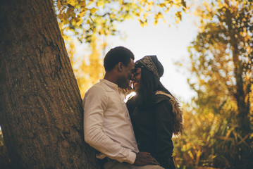 Wall Mural - Young african couple have fun in the autumn forest.