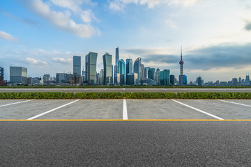 Wall Mural - empty car park with city skyline background.