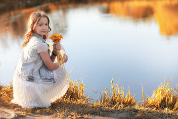 Girl walking in the autumn park. Autumn in the city, girl with d